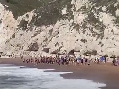Beachgoers in Dorset made a human chain in a bid to rescue someone at sea