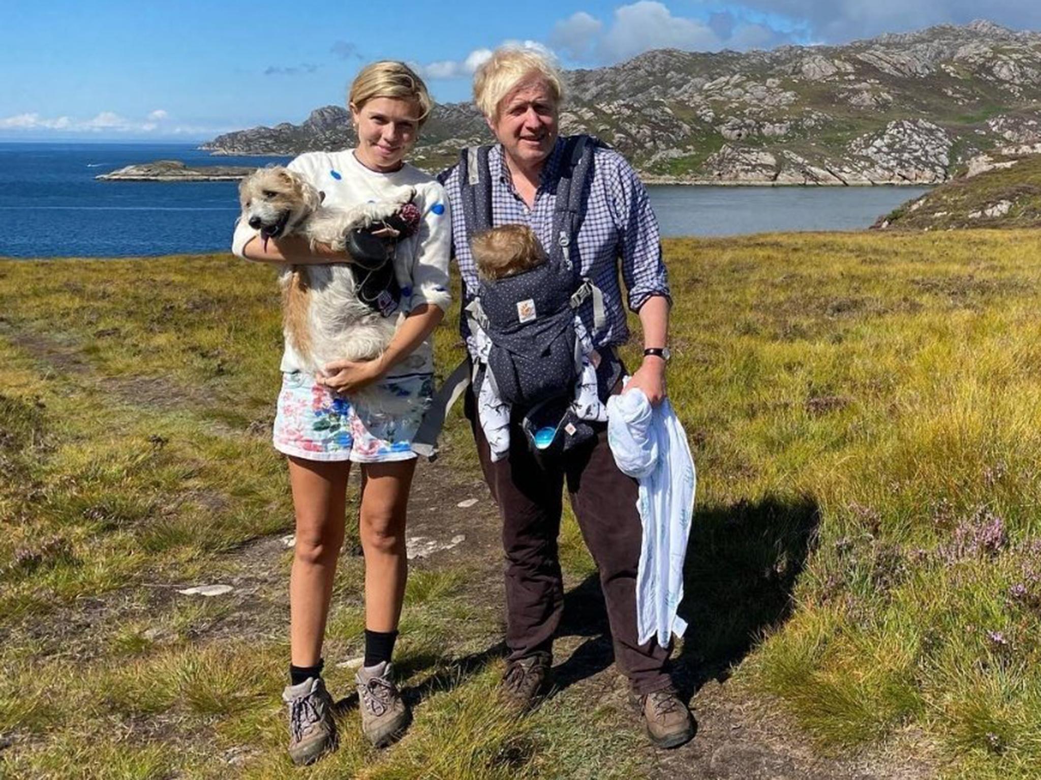 Boris and Carrie Johnson posing with dog Dilyn and son Wilfred in the Scottish Highlands