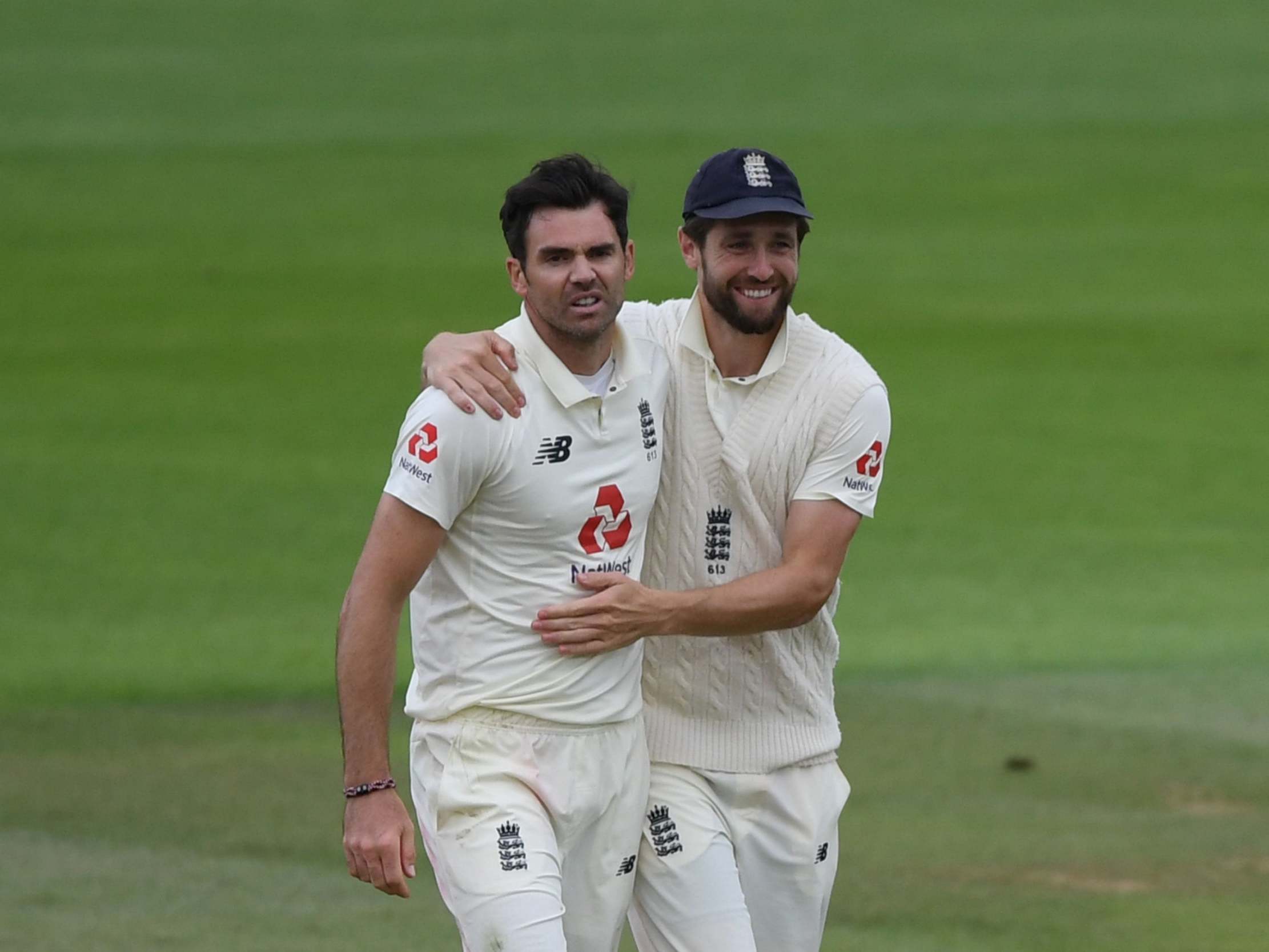 A snarling James Anderson is congratulated on his five-fer by Chris Woakes