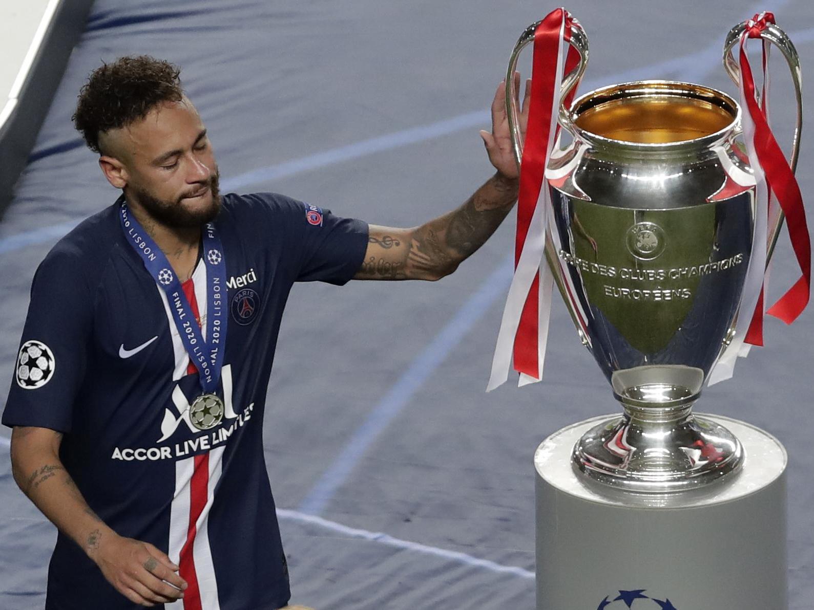 PSG's Neymar touches the trophy