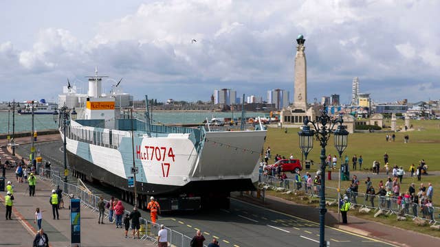 Restored World War Two landing craft LCT 7074 is transported from from the Naval Base in Portsmouth to its final resting place at the D-Day Story at Southsea