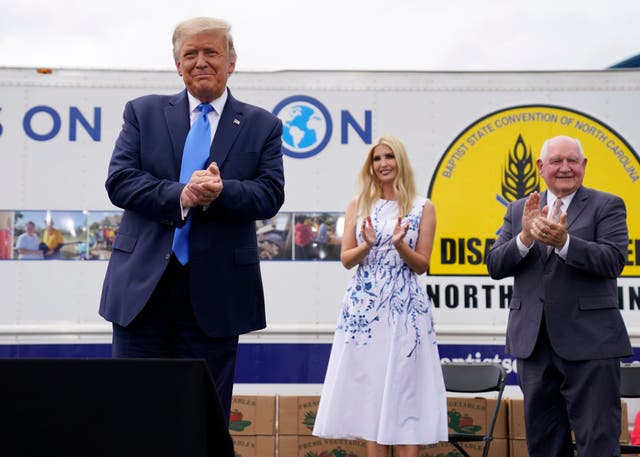 Donald Trump with Ivanka Trump and agriculture secretary Sonny Perdue at a Farmers to Families Food Box Program event in Mills River, North Carolina