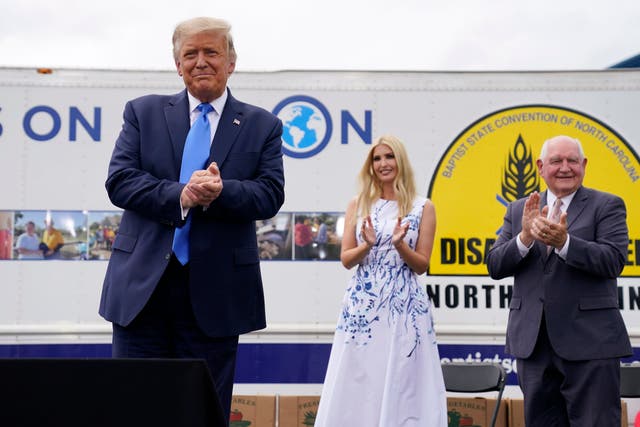 Donald Trump with Ivanka Trump and agriculture secretary Sonny Perdue at a Farmers to Families Food Box Program event in Mills River, North Carolina