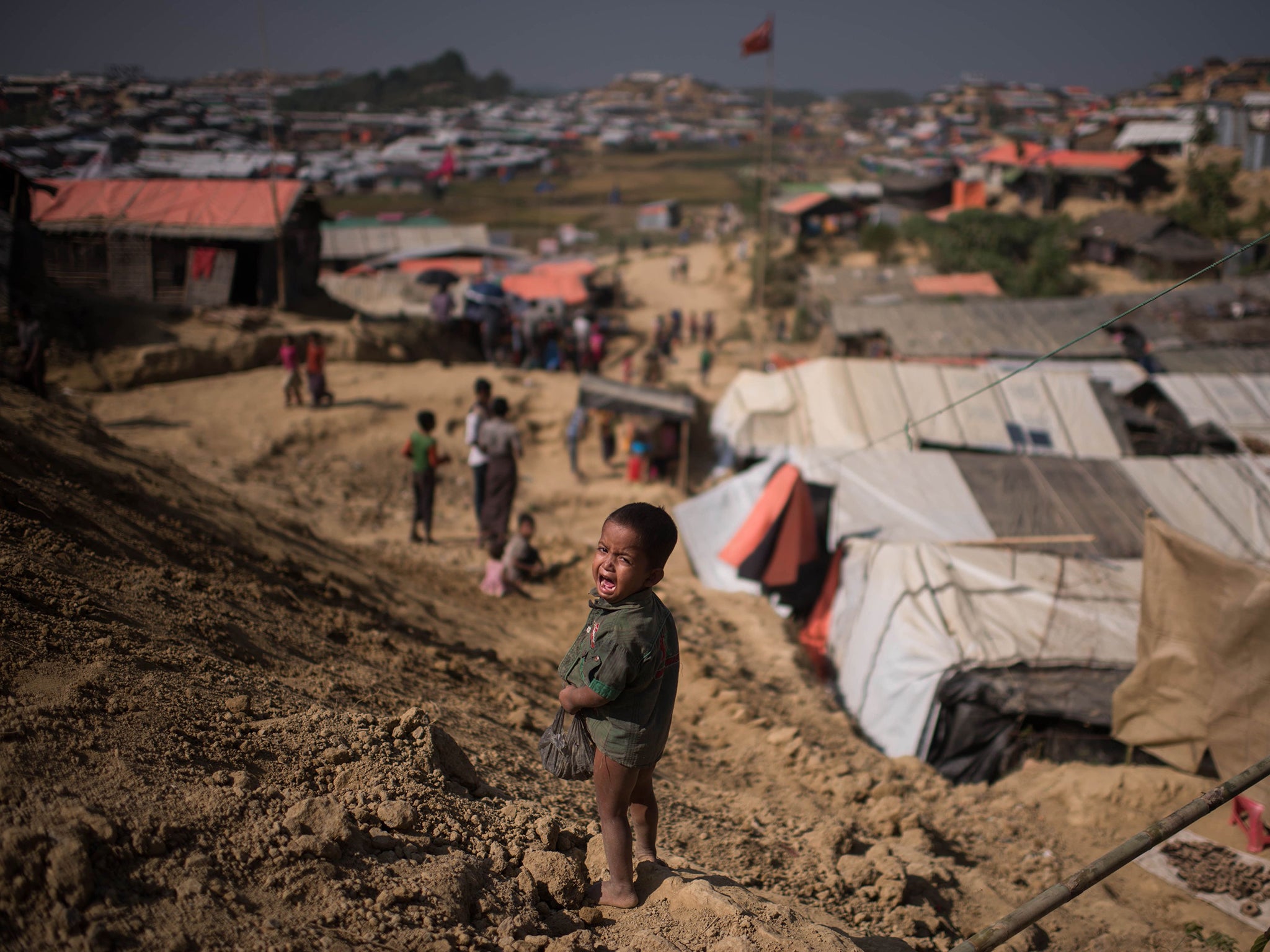 A Rohingya child cries as he stands near the Thyangkhali refugee camp in Cox’s Bazaar