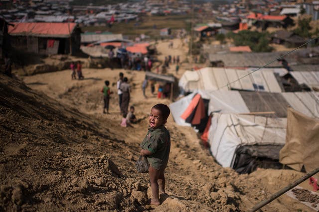 A Rohingya child cries as he stands near the Thyangkhali refugee camp in Cox's Bazaar