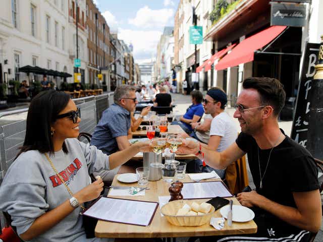 Diners enjoy their drinks at a restaurant in London on 3 August 2020 as Eat Out to Help Out scheme begins