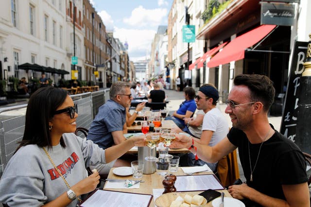 Diners enjoy their drinks at a restaurant in London on 3 August 2020 as Eat Out to Help Out scheme begins