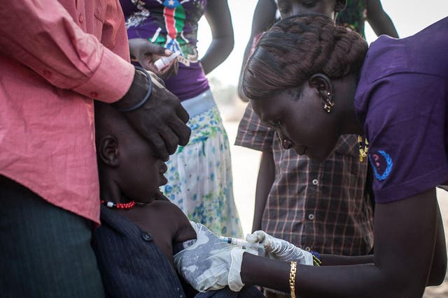A member of Doctors Without Borders (MSF) administers polio vaccines to children in Minkammen, south Sudan