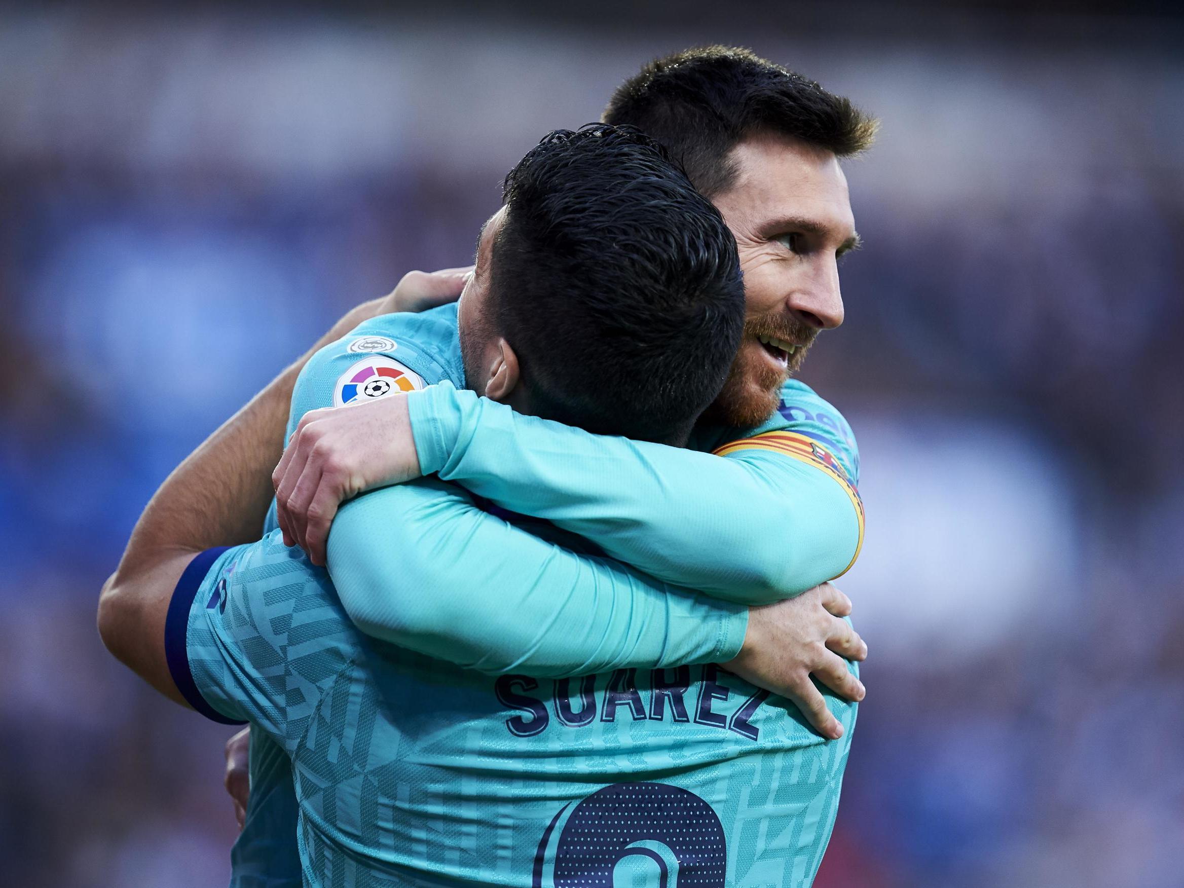 Luis Suarez of FC Barcelona celebrates with teammate Lionel Messi