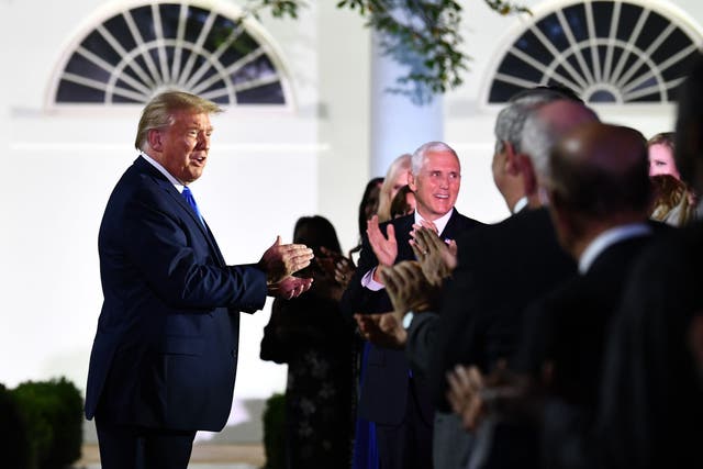 Donald Trump, alongside Vice President Mike Pence, arrives to listen to US First Lady Melania Trump address the Republican Convention during its second day from the Rose Garden of the White House