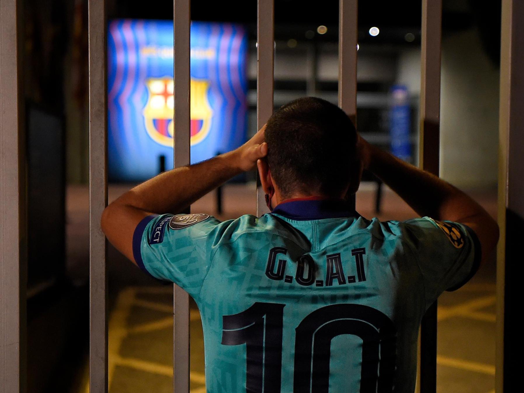 A Barcelona fan with a shirt referencing Lionel Messi at the Nou Camp