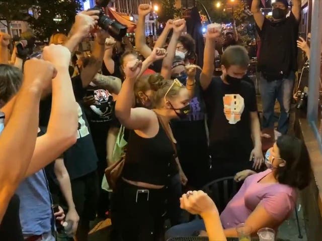 Black Lives Matter protesters confront a diner at a Washington DC restaurant who declined to raise her fist in protest