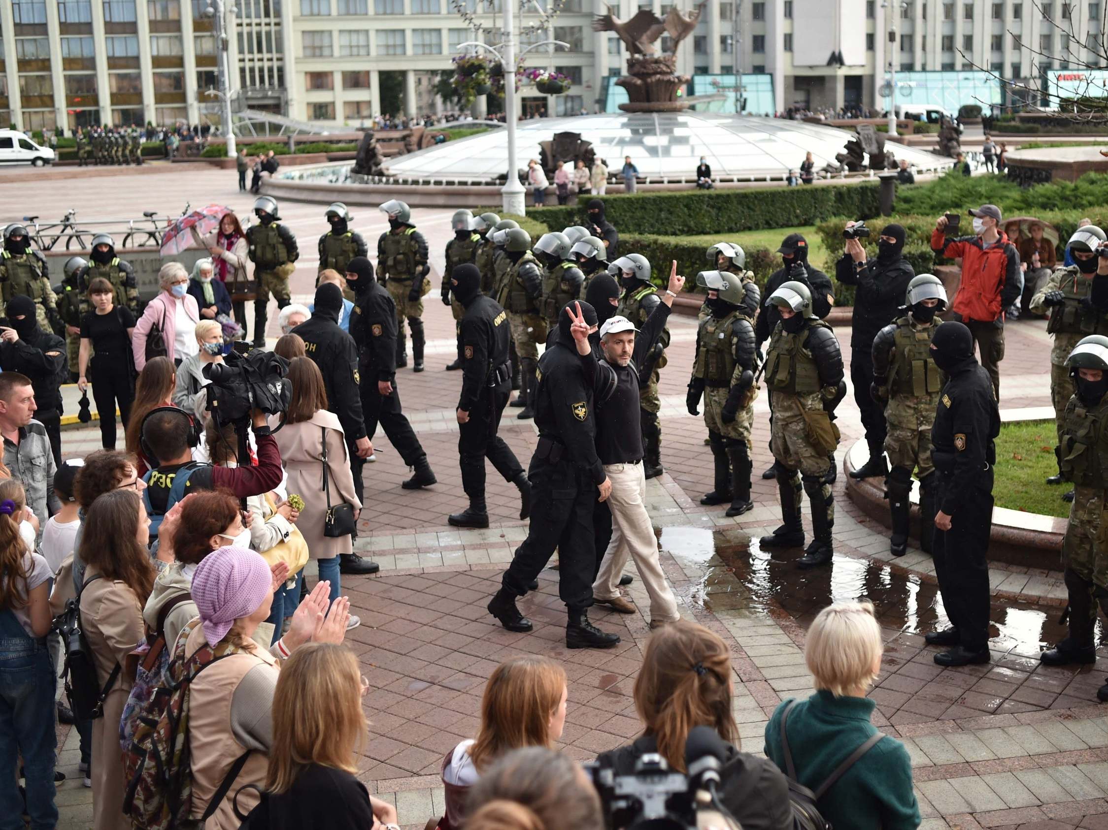 A protester is detained by police in Minsk
