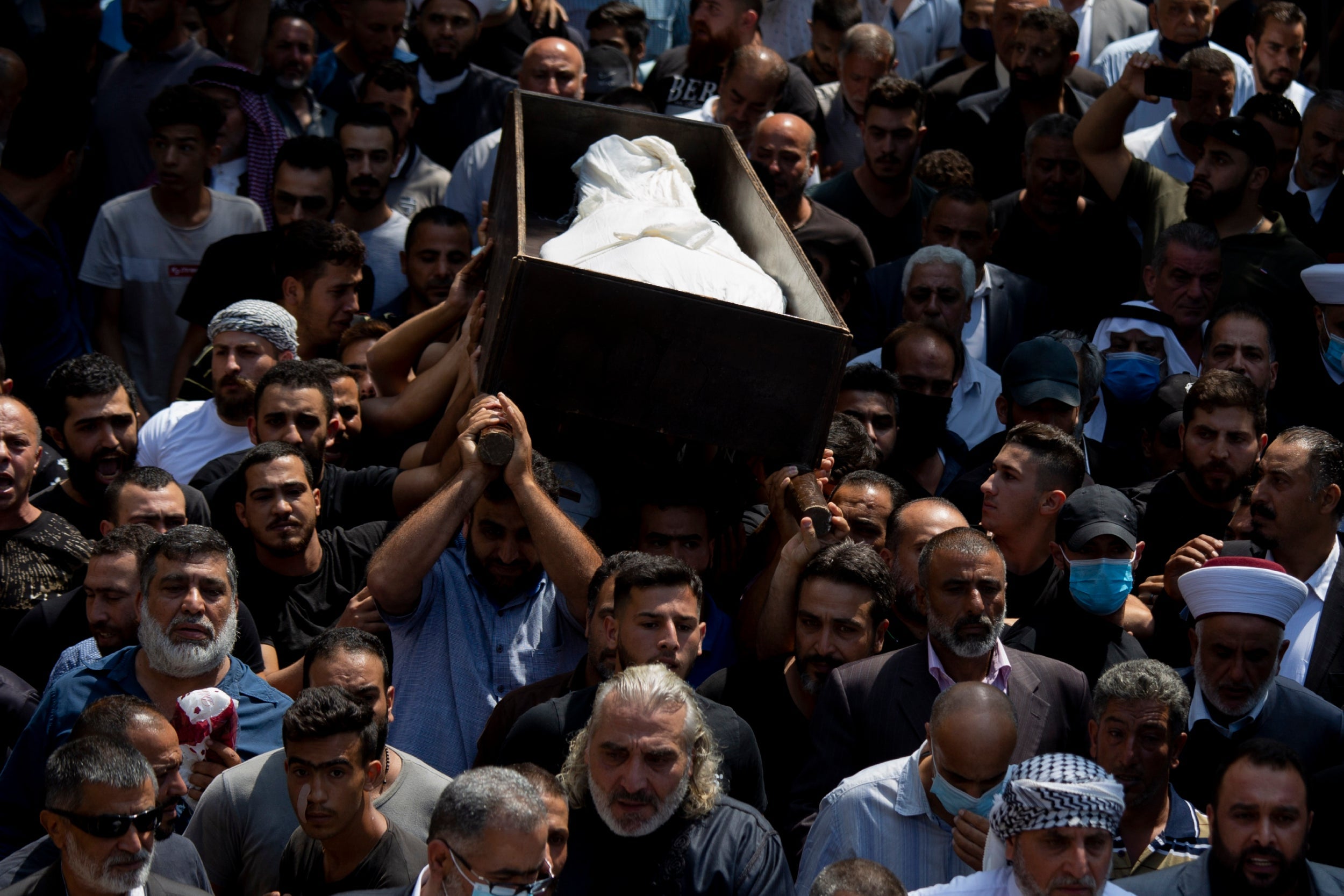 Relatives and friends of Hassan Zaher Ghosn, 14, who was killed the night before, carry his coffin