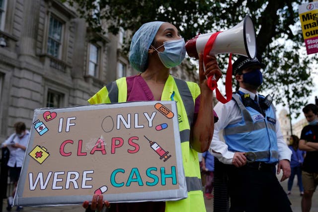 Workers from the National Health Service (NHS) demonstrate outside Downing Street