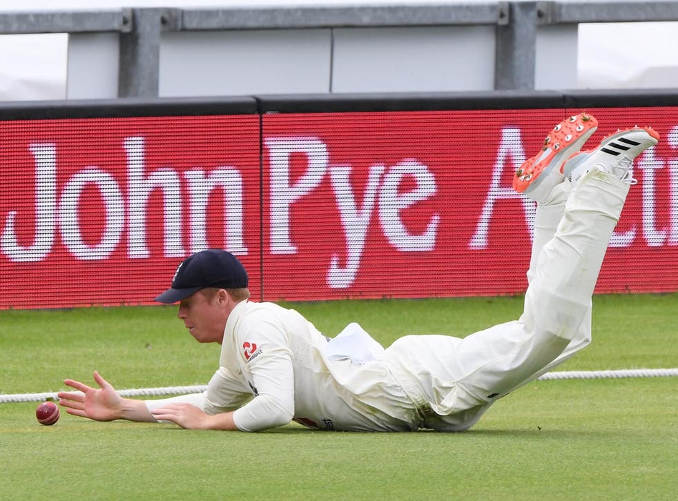 Ollie Pope of England dives to stop a boundary