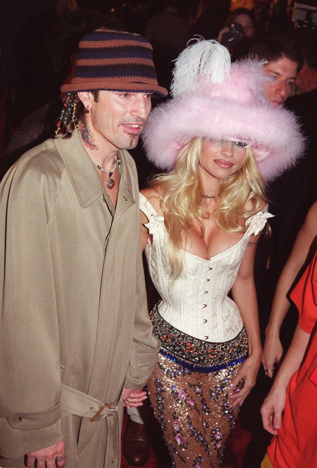 <I>Baywatch</I> star Pamela Anderson attended the VMAs alongside Tommy Lee in 1999 wearing a white bustier, pink furry hat, and embellished trousers. In 2018, Kim Kardashian replicated the outfit with her best friend Jonathan Cheban for Halloween.