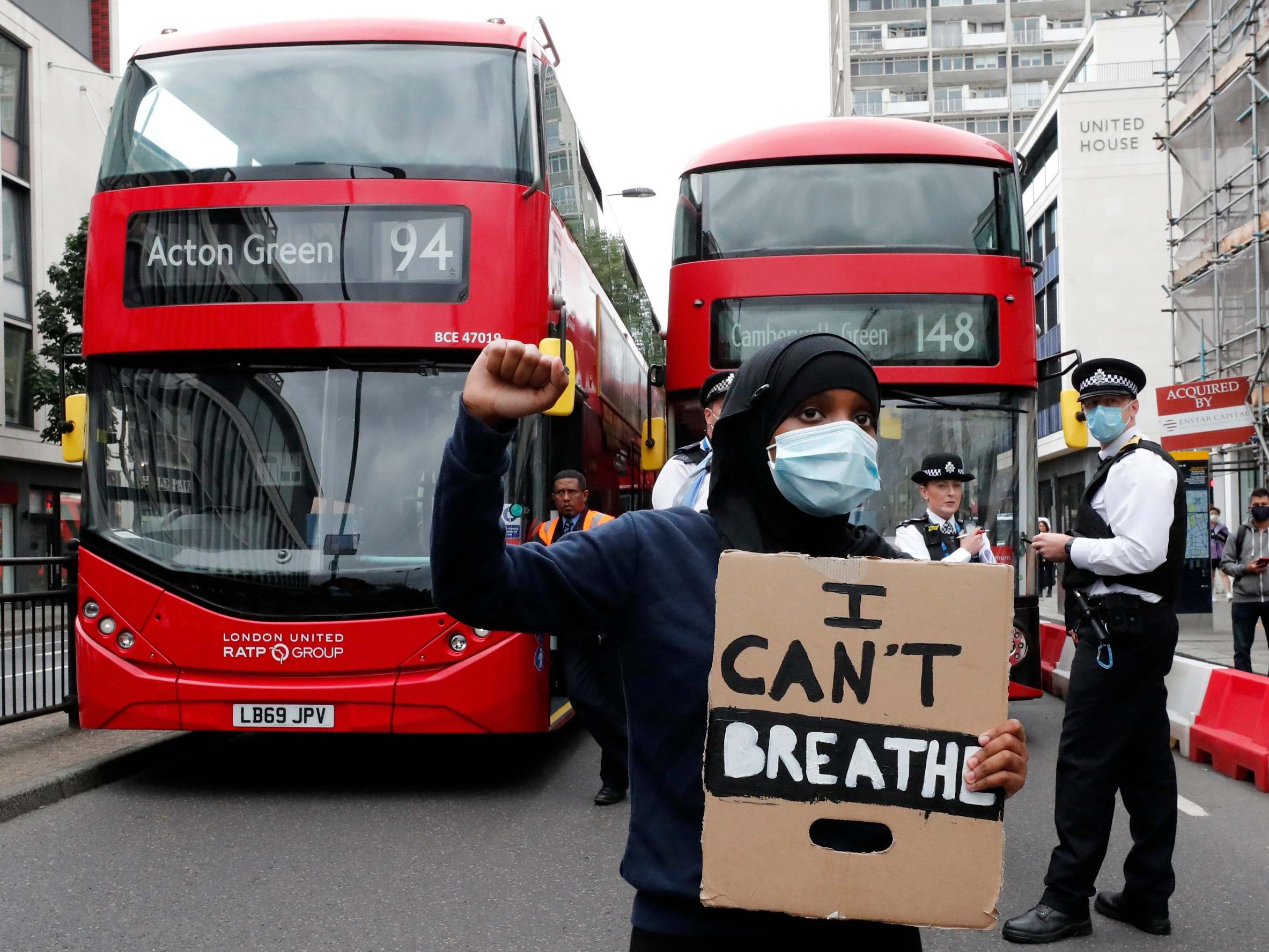 A protester blocks the road in Notting Hill during the march.