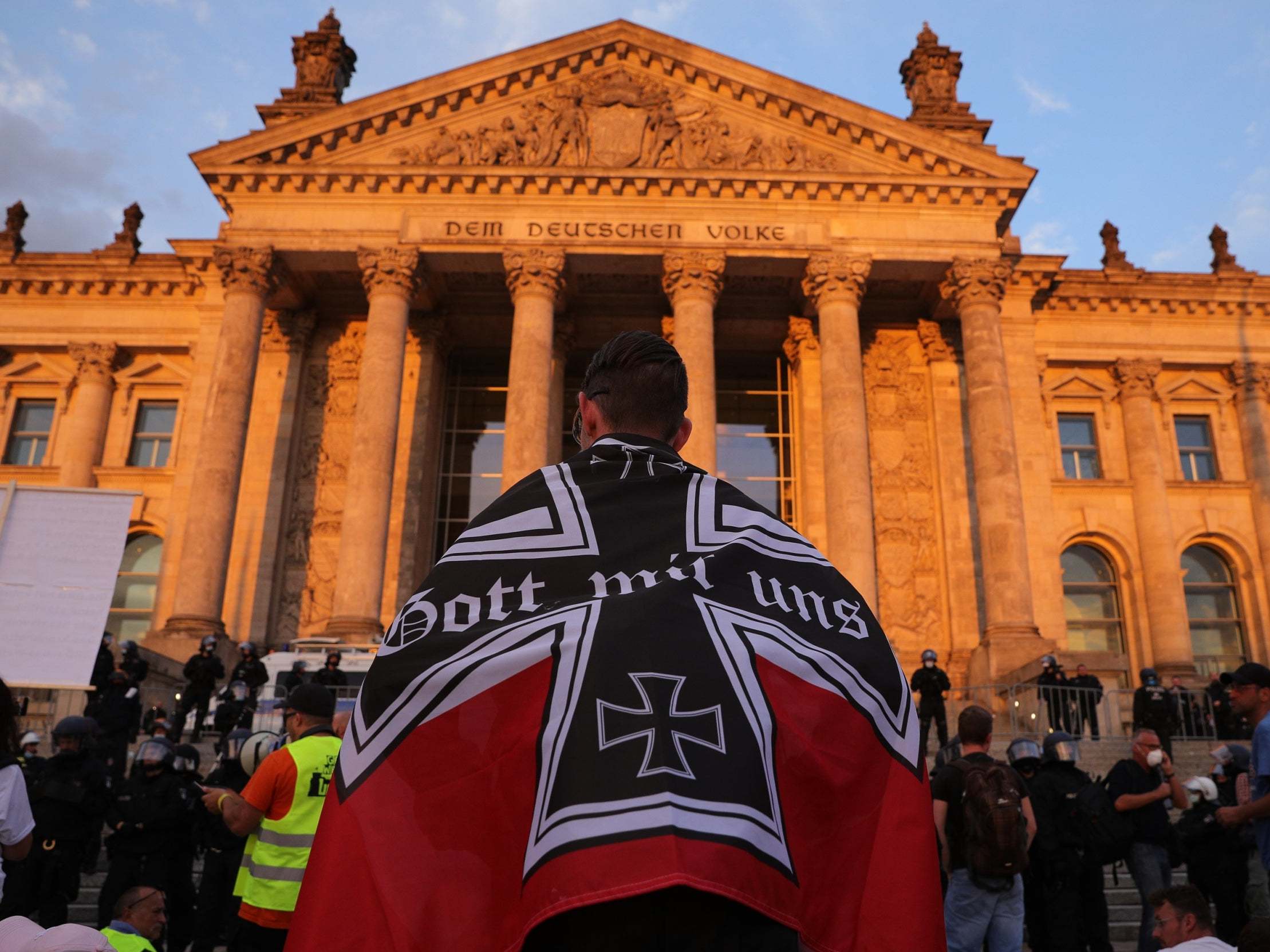 A protester wrapped in an imperial German flag.
