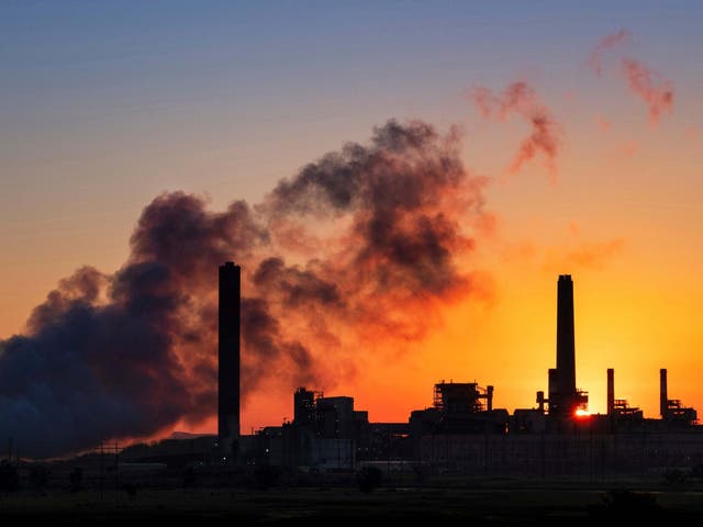 The Dave Johnson coal-fired power plant is silhouetted against the morning sun in Glenrock, Wyoming in 2018