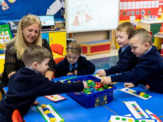 Pupils enjoy their first day back in class at St John the Baptist Primary School in west Belfast, Northern Ireland.