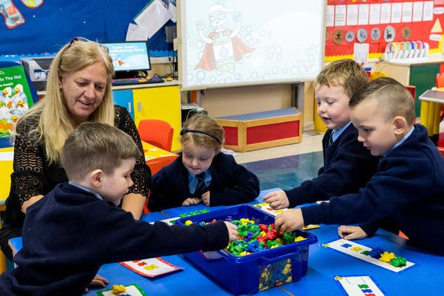 Pupils enjoy their first day back in class at St John the Baptist Primary School in west Belfast, Northern Ireland.