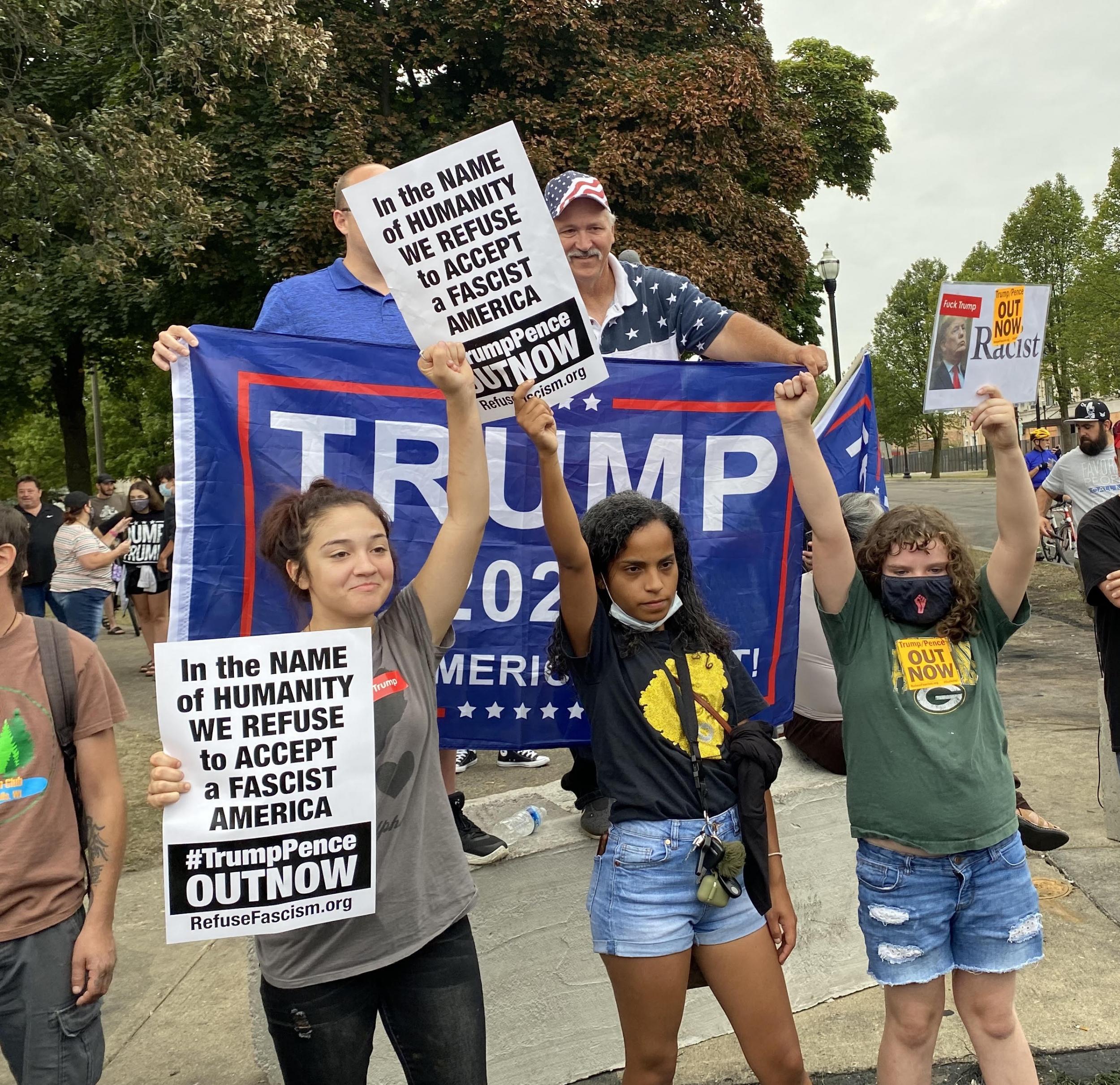 Protesters stand in front of Trump supporters during the president’s visit to Kenosha, Wisconsin. (Richard Hall / The Independent )