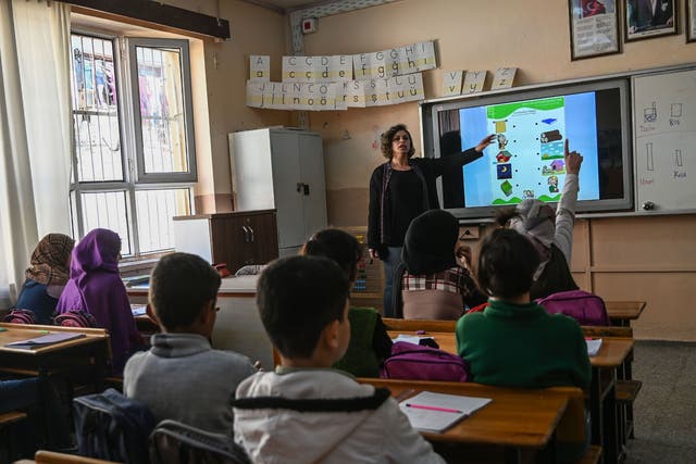 A teacher gives a Turkish language class to Syrian children at Sehit Duran primary school in Adana