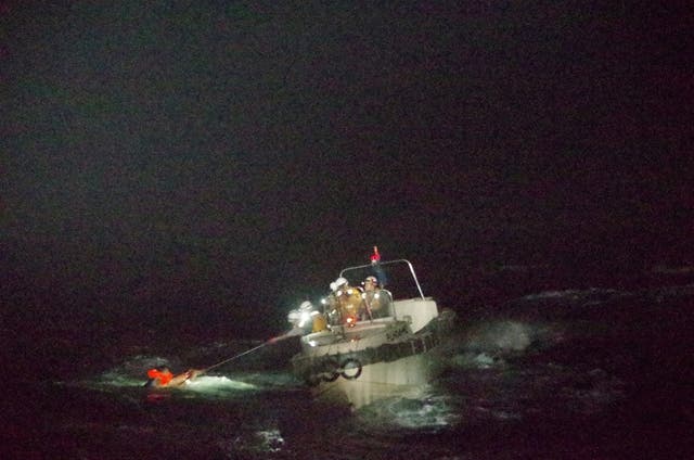 A Filipino crew member is pulled from the sea by Japanese coastguard after surviving the sinking of Gulf Livestock 1