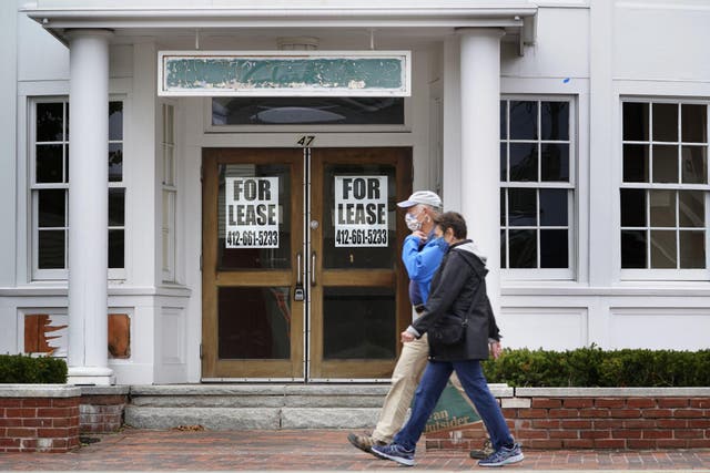 Shoppers pass by a former Clark's shoe store that is now one of several vacant retail spaces among the outlet shops in Freeport, Maine, 2 September, 2020