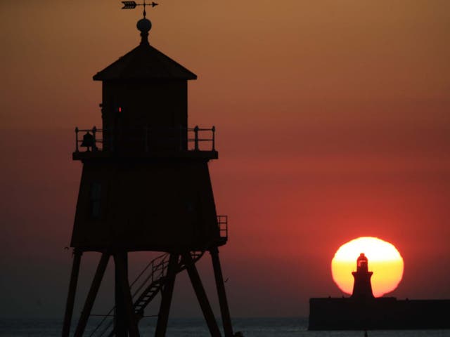 The sun rising over South Shields pier and lighthouse on the North East coast