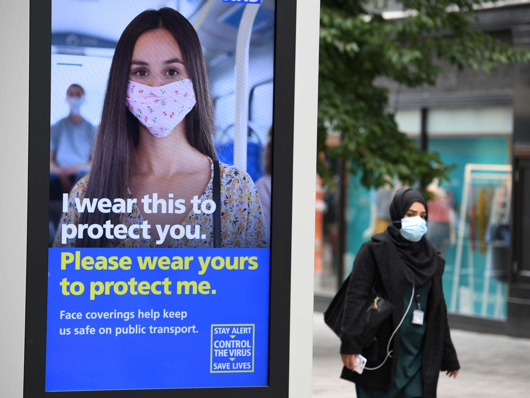 A pedestrian wears a facemask in the city centre of Leeds
