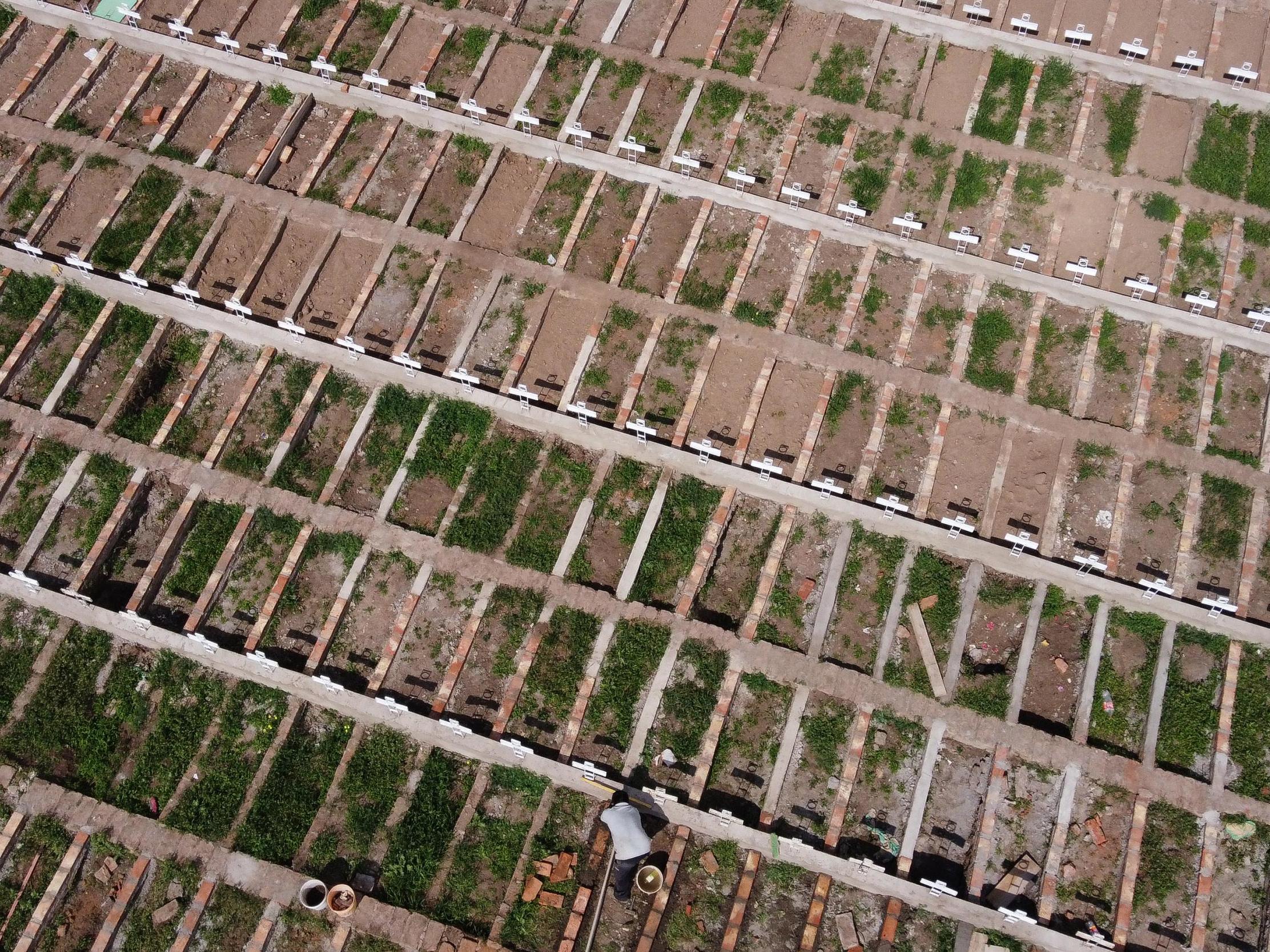 Aerial view as a cemetery worker prepares graves for Covid-19 victims at Cementerio General in Santiago, Chile