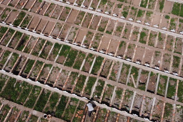 Aerial view as a cemetery worker prepares graves for Covid-19 victims at Cementerio General in Santiago, Chile
