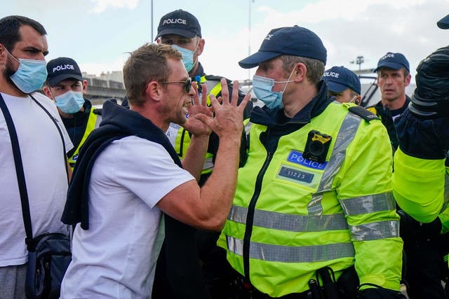 Police move anti-migrant protesters demonstrating against immigration and the increase in journeys made by refugees crossing the English Channel in dinghies to the UK