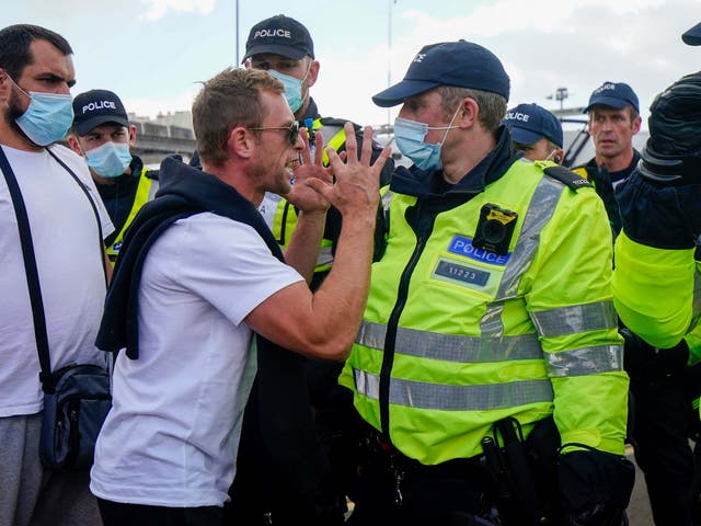 Police move anti-migrant protesters demonstrating against immigration and the increase in journeys made by refugees crossing the English Channel in dinghies to the UK