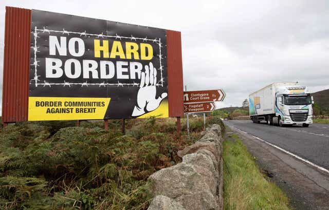 <p>A lorry passes an anti-Brexit pro-Irish unity billboard</p>