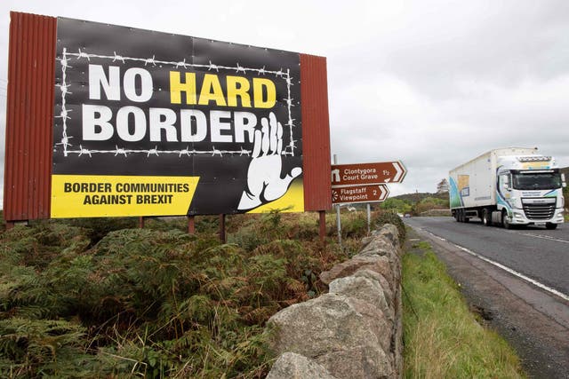 <p>A lorry passes an anti-Brexit pro-Irish unity billboard</p>