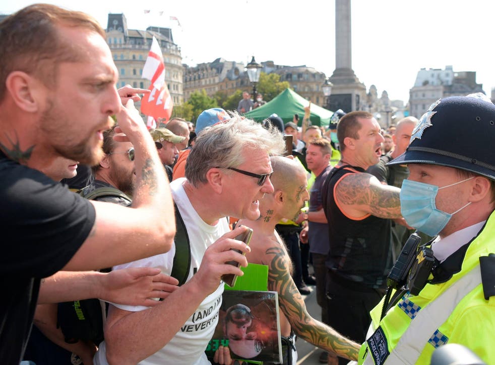 <p>Demonstrators argue with police in Trafalgar Square, London</p>