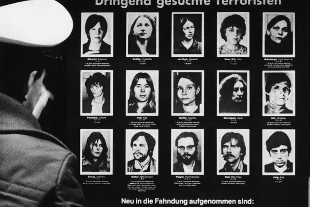 <p>A policeman reading a wanted poster for the Baader-Meinhof Gang</p>