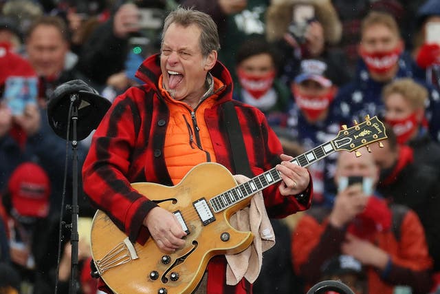 <p>Ted Nugent performs ‘The Star-Spangled Banner’ during a Trump campaign rally in Lansing, Michigan (Ge</p>