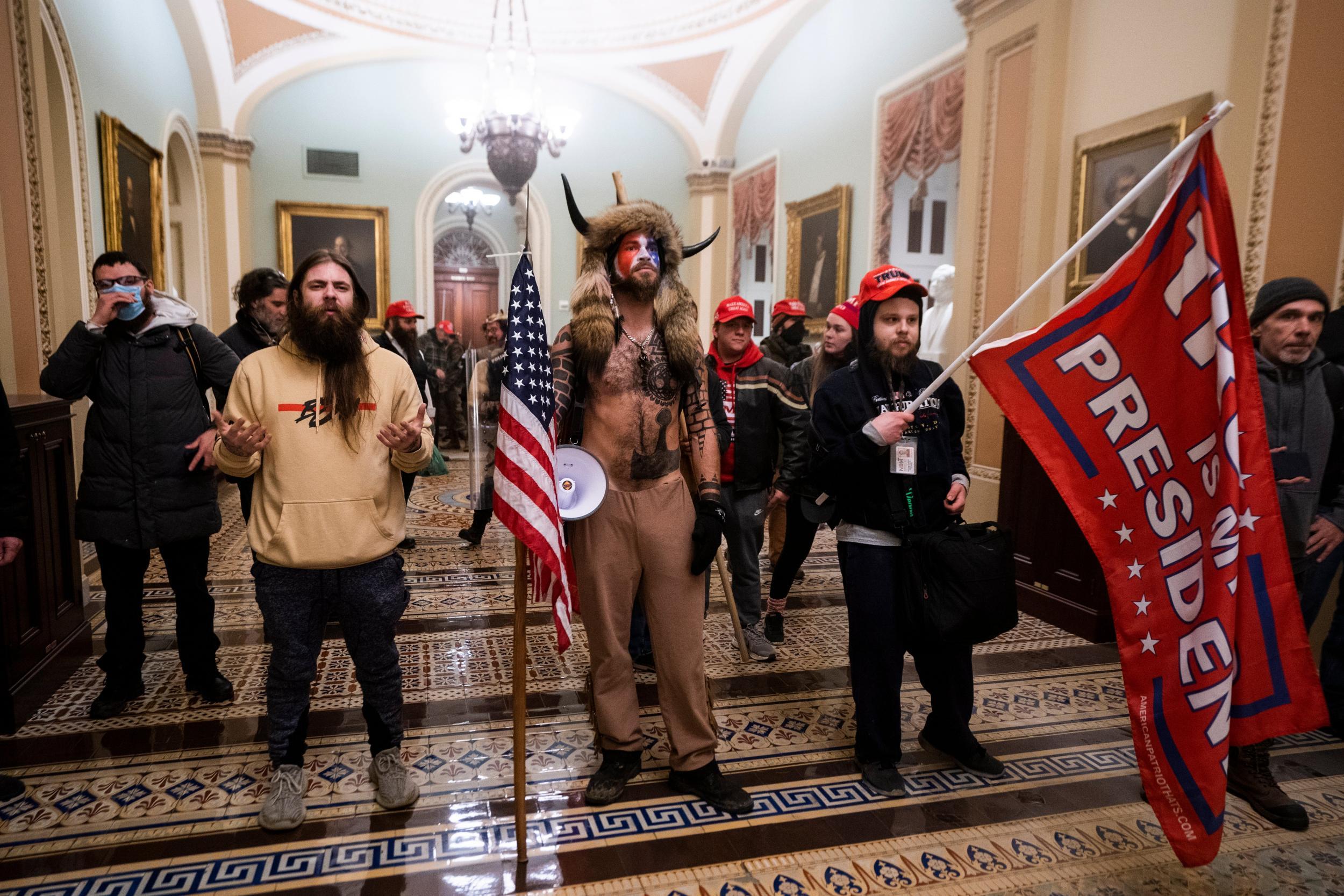 Rioters, including the ‘QAnon Shaman’ (mi