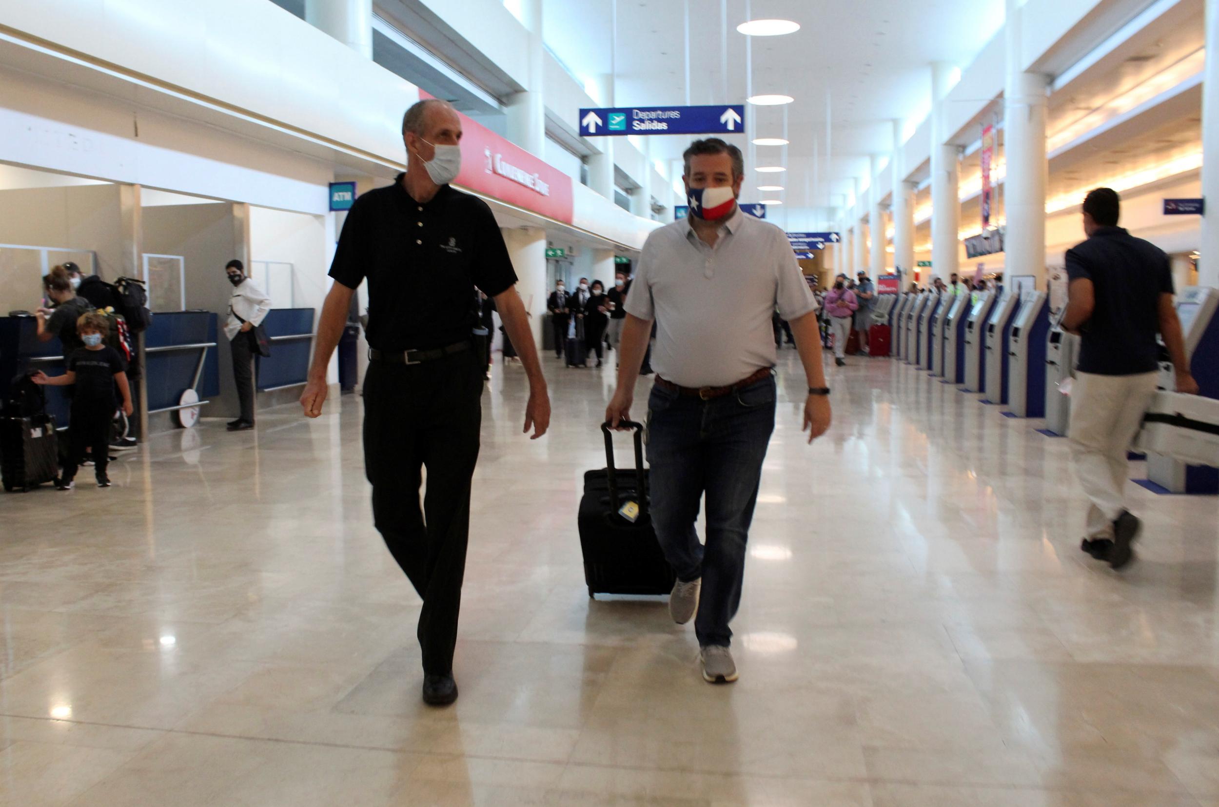 Cruz cutting a lonely figure at Cancun International in February 2021