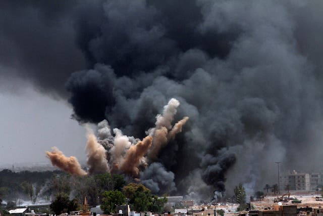 <p>Smoke rises to the sky after a Nato airstrike in Tripoli, Libya, in 2011</p>