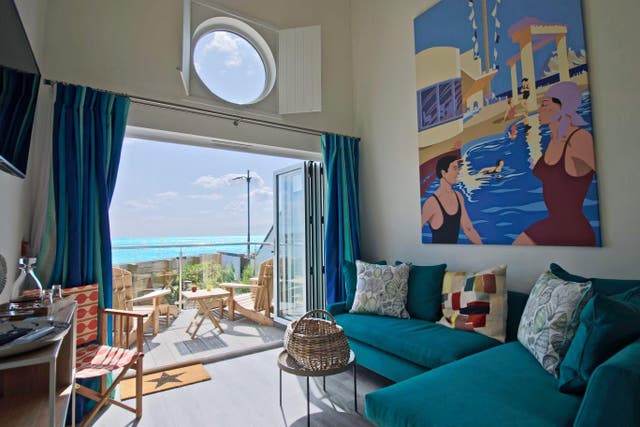 <p>Beachcroft Beach Hut Suites look out onto pebbly Felpham Beach in West Sussex</p>