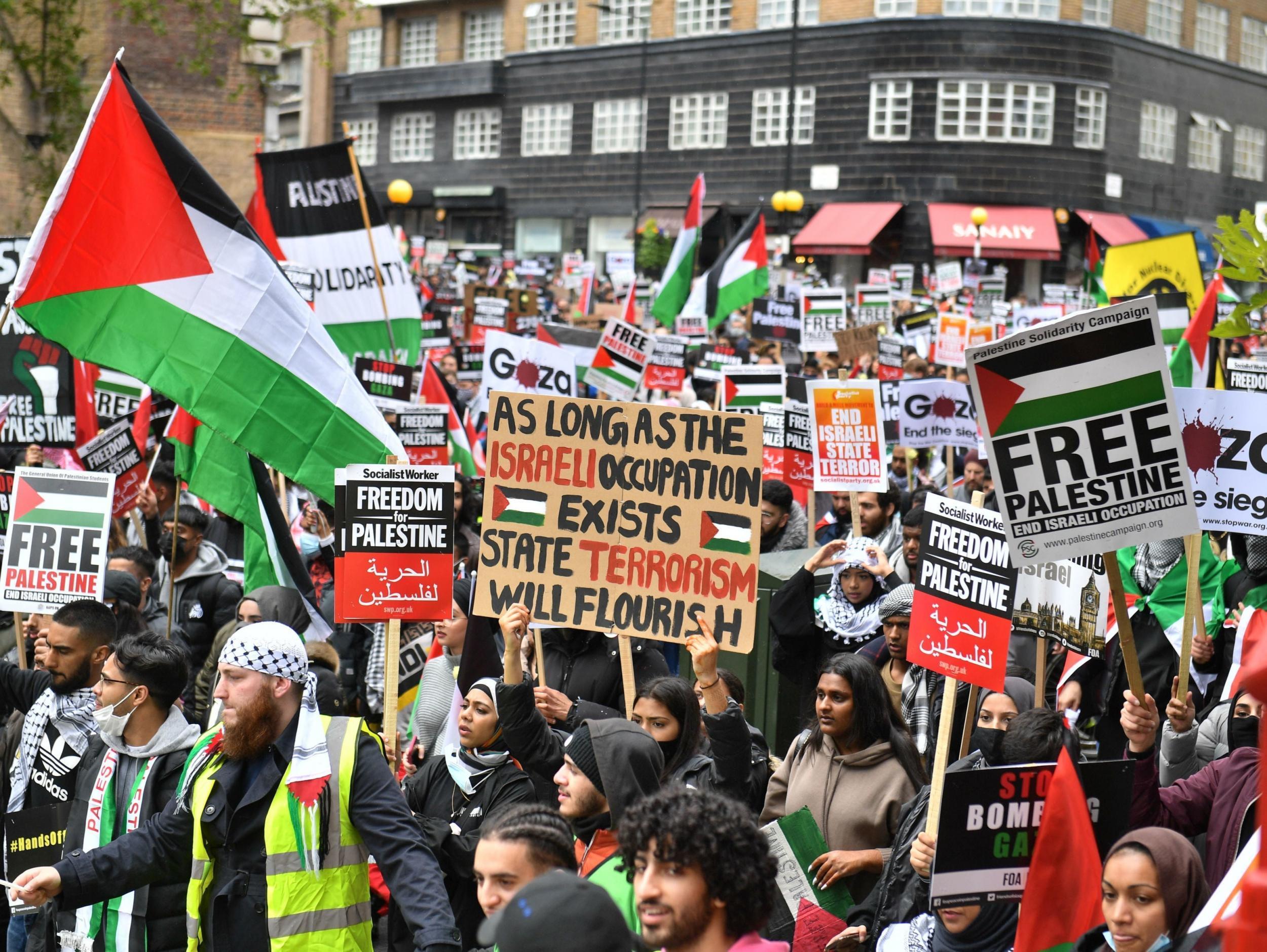Pro-Palestinian demonstrators walk through Kensington to the Israeli embassy in London