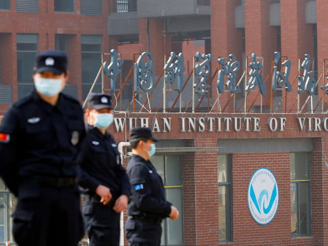 <p>Chinese officials await the WHO team’s visit to the Wuhan Institute of Virology</p>