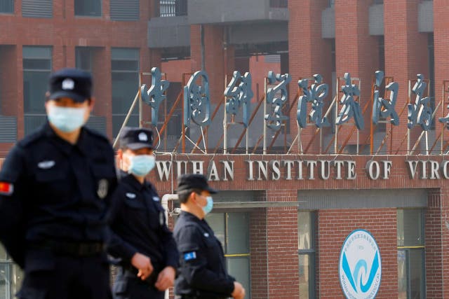 <p>Chinese officials await the WHO team’s visit to the Wuhan Institute of Virology</p>