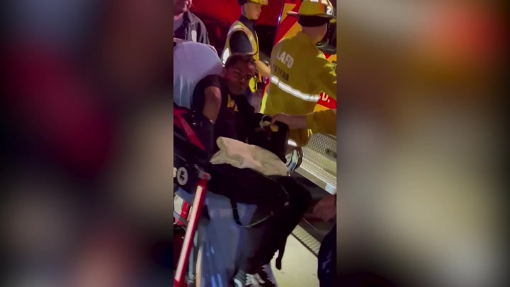 Footage of Dave Chappelle's 'attacker' loaded into ambulance with injured arm