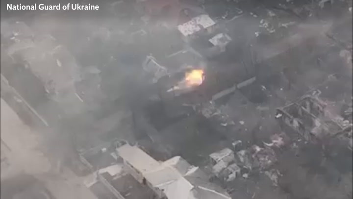 Ukrainian tank shoots through building and hits Russian armoured vehicle